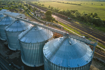 Aerial view of industrial ventilated silos for long term storage of grain and oilseed. Metal elevator for wheat drying in agricultural zone