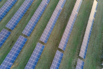 Aerial view of large sustainable electrical power plant with rows of solar photovoltaic panels for producing clean ecological electric energy. Renewable electricity with zero emission concept