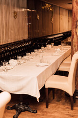 Lots of beautiful crockery and cutlery on a long table in a restaurant