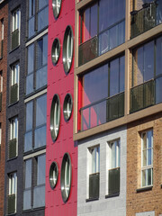 Fototapeta premium Close up of new modern building brick facade with red, brown blocks in Noblessner district. Tallinn, Estonia, Europe. April 2022