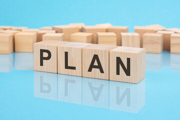 letters Plan made with wood building blocks. blue background. business concept