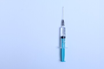 Medical syringe on a white background. A syringe for injection. The concept of health and beauty