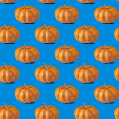 Seamless pattern with pumpkin on blue background for wallpaper, fabric or wrapping-paper. Minimal vegetable concept