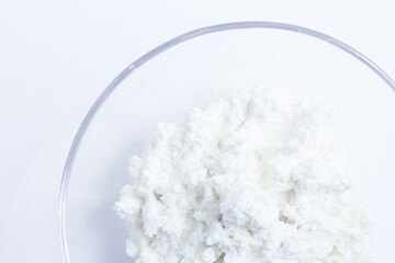 cottage cheese in a glass transparent bowl isolated on a white background