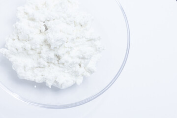 cottage cheese in a glass transparent bowl isolated on a white background