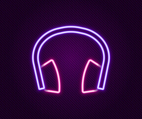 Glowing neon line Noise canceling headphones icon isolated on black background. Headphones for ear protection from noise. Colorful outline concept. Vector