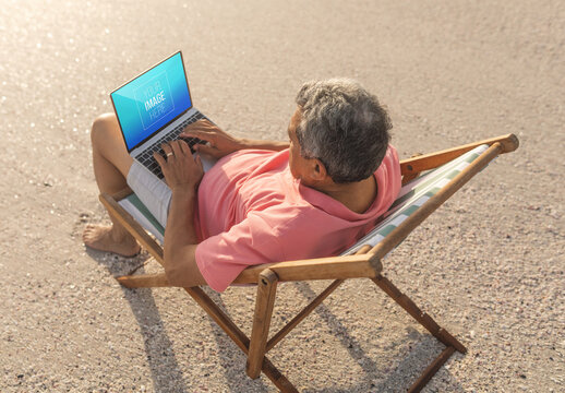Man with Laptop on Beach Mockup