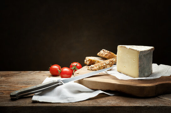 Cow's milk caciotta, Formaggella bergamasca. Rustic snack with Italian cheese, cherry tomatoes and wholemeal bread, space for text.