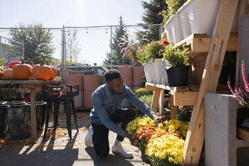 Man shopping for flowers on sunny patio