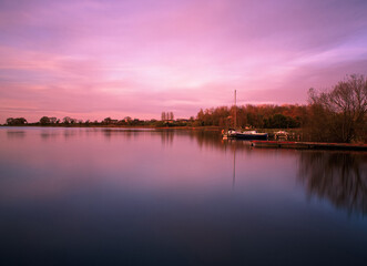 Fototapeta premium A Beautiful Dusky Pink Sunset Over Lough Neagh, Northern Ireland