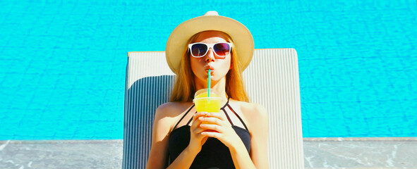 Summer vacation, happy relaxing young woman lying on deckchair with cup of juice on pool background