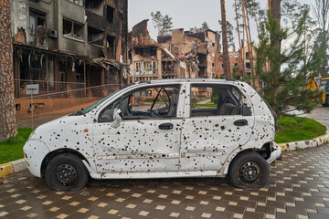 2022 Russian invasion of Ukraine war. War ruins city damage car. Terror attack bomb shell of civilian bombed. Disaster area. cars beaten by shrapnel and burnt