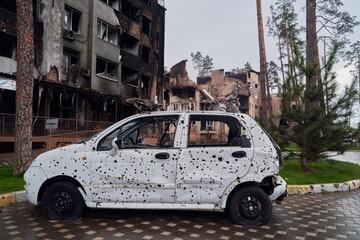 2022 Russian invasion of Ukraine war. War ruins city damage car. Terror attack bomb shell of...