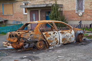 2022 Russian invasion of Ukraine war. War ruins city damage car. Terror attack bomb shell of...