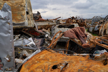 2022 Russian invasion of Ukraine war. War ruins city damage car. Terror attack bomb shell of civilian bombed. Disaster area. cars beaten by shrapnel and burnt