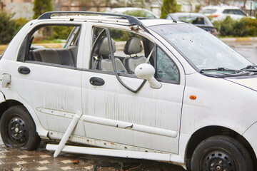 2022 Russian invasion of Ukraine war. War ruins city damage car. Terror attack bomb shell of...