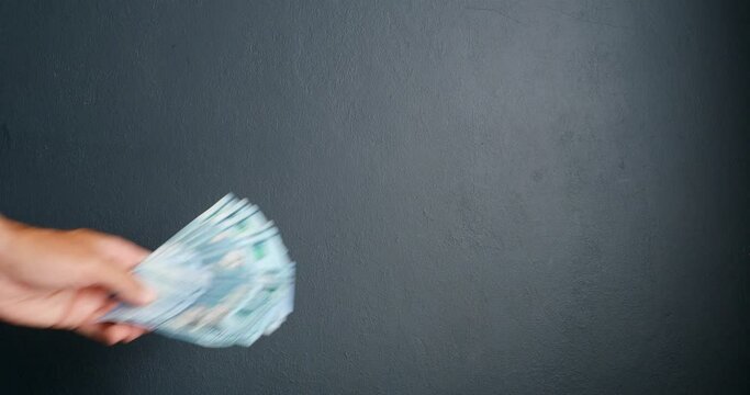 Man hands over money in Dominican pesos.