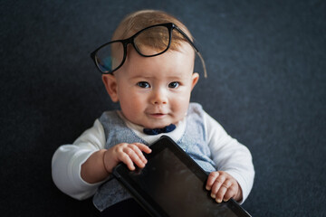 intelligent Cute baby genius who looks like a little student well dressed in vest and bow tie with...