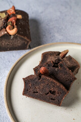 Homemade banana bread with nut on gray background. Healthy dessert concept. Top view, close- up, copy space.