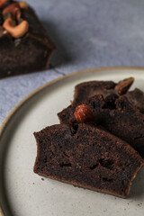 Homemade banana bread with nut on gray background. Healthy dessert concept. Top view, close- up, copy space.