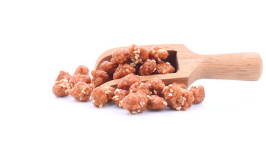 Honey covered, coated peanuts with sesame seeds isolated on white background