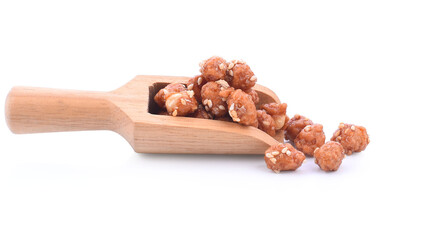 Honey covered, coated peanuts with sesame seeds isolated on white background