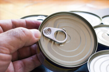 Mature man holding a canned food can. Long shelf life food .