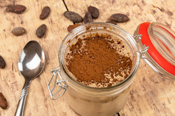 top view of a tiramisu in a pot on a wooden table