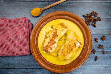 top view of chicken with coconut milk and curry in a dish