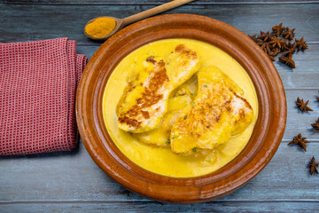 top view of chicken with coconut milk and curry in a dish