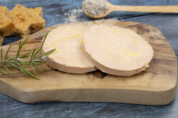 Slices of foie gras on wooden board