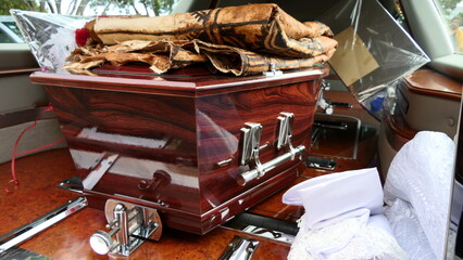 Fototapeta na wymiar closeup shot of a funeral casket or coffin in a hearse or chapel or burial at cemetery 