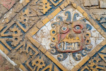 The totem of the sun god on the wall in the remains of the Moon Palace of the Moche Dynasty. This is also a symbol of Moche culture.