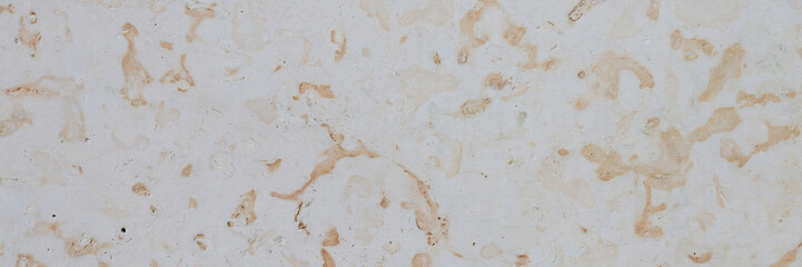 Dolomite texture. Natural rock with beautiful beige patterns on the surface. Polished flat stone. Classic luxury decoration building material. Wide panoramic texture for background and design.