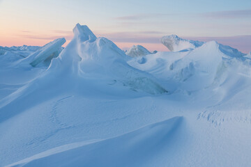 Winter arctic landscape. View of snow and ice at sunset. Ice hummocks on the frozen sea in the...