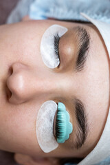 Caucasian woman on eyelash lamination procedure. Before and after. 