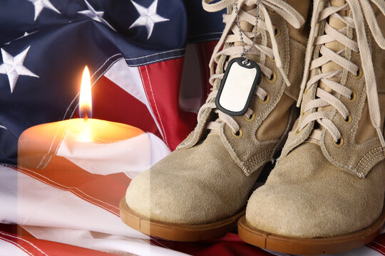 Double exposure of burning candle, military boots with tag and USA flag. Memorial Day