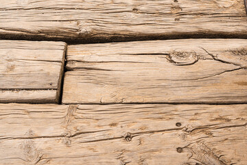 Surface of brown wooden planks with cracks