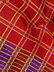 The background of the plaid sarong fabric texture is combined with red and blue yellow stripes