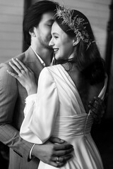 Black and white photo of happy young couple in love hugging each other