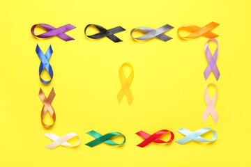 Set of colorful awareness ribbons on yellow background. World Cancer Day