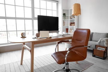 Workplace with computer in light room