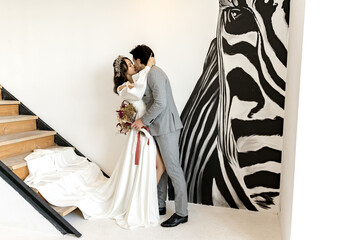Happy young wedding couple kissing. Bride and groom