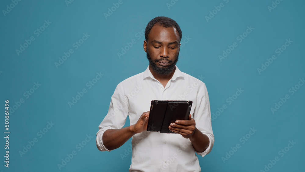 Poster businessman working on digital tablet to browse internet, using wireless portable gadget for social 