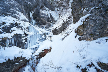 Fototapeta na wymiar Frozen waterfall in winter. Icicles on the rock.