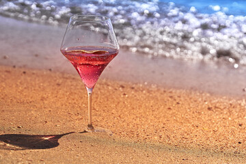 Wine glass with a cocktail by the sea.