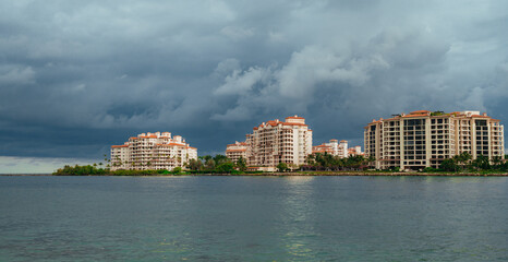 houses on the island miami usa florida buildings sky beautiful clouds sea reflection sun 