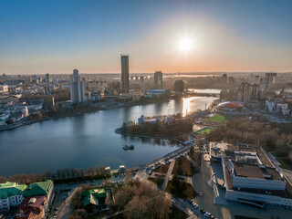 Yekaterinburg city and pond aerial panoramic view at early spring or autumn in clear sunset.