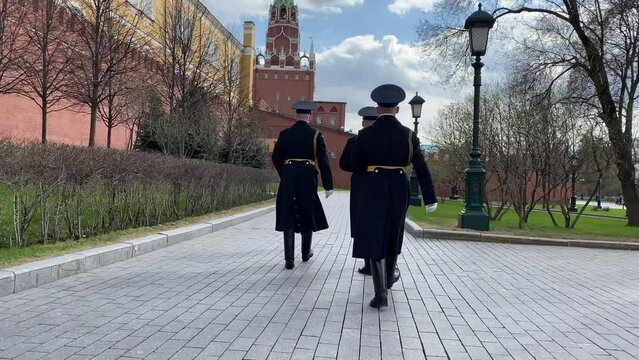 Moscow, Russia, April 28, 2022: Russian Honor Soldiers marching near Kremlin wall through the Alexander Garden on Red Square. Spring sunny day. Center of Moscow. Historical sights. Ceremony.