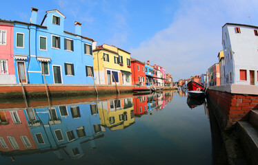 Fototapeta na wymiar reflection on the water of the colorful houses on the island of Burano near Venice in Northern Italy in Europe